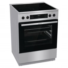 Sivi električni šporet sa staklokeramičkom pločom i potapajućim dugmićima.